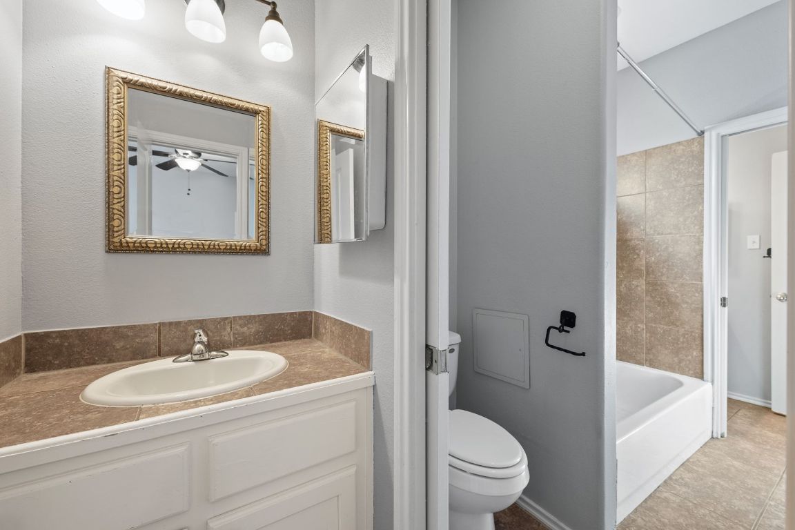 2906 Pearl Street, Unit B Austin, TX 78705 - Photo 22 of 30 Full bathroom with vanity, shower / bath combination, and tile patterned flooring