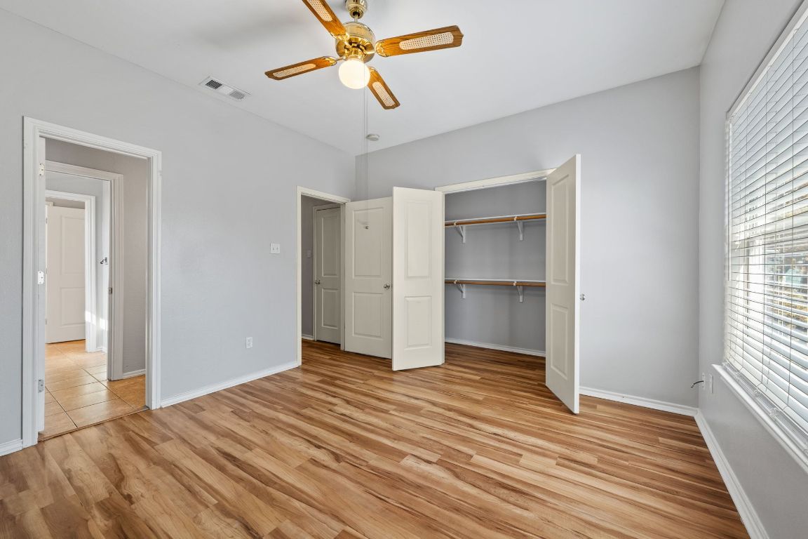 2906 Pearl Street, Unit B Austin, TX 78705 - Photo 24 of 30 Unfurnished bedroom featuring light wood-style floors, ceiling fan, and a closet