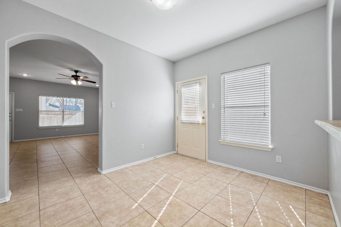 2906 Pearl Street, Unit B Austin, TX 78705 - Photo 8 of 30 Unfurnished room with a ceiling fan, light tile patterned floors, and arched walkways