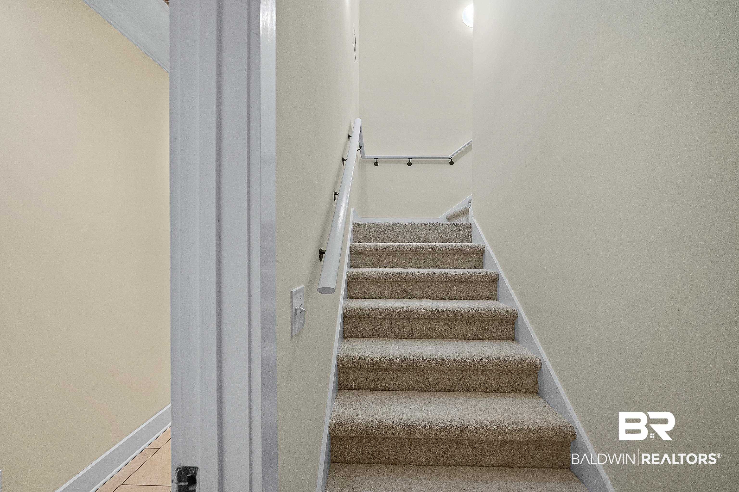 356 Liberty Street Fairhope, AL 36532 - Photo 24 of 39 Stairs with baseboards and carpet
