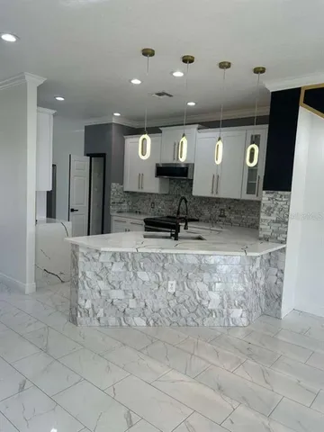 a living room with a fireplace furniture a ceiling fan and a rug