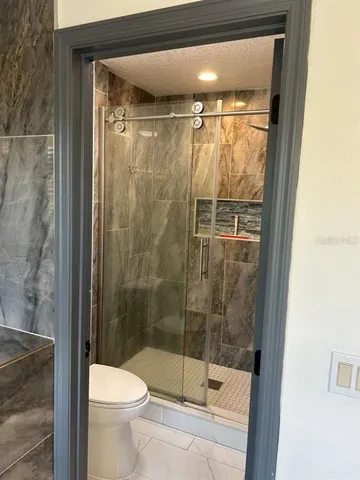 a view of a utility room with wooden floor and cabinet