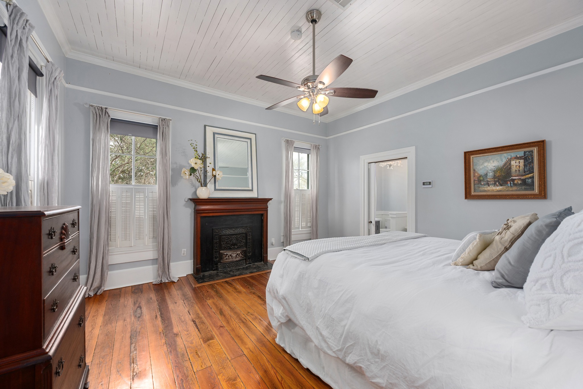 603 East 7th Street Georgetown, TX 78626 - Photo 13 of 33 a spacious bedroom with a bed and a fireplace