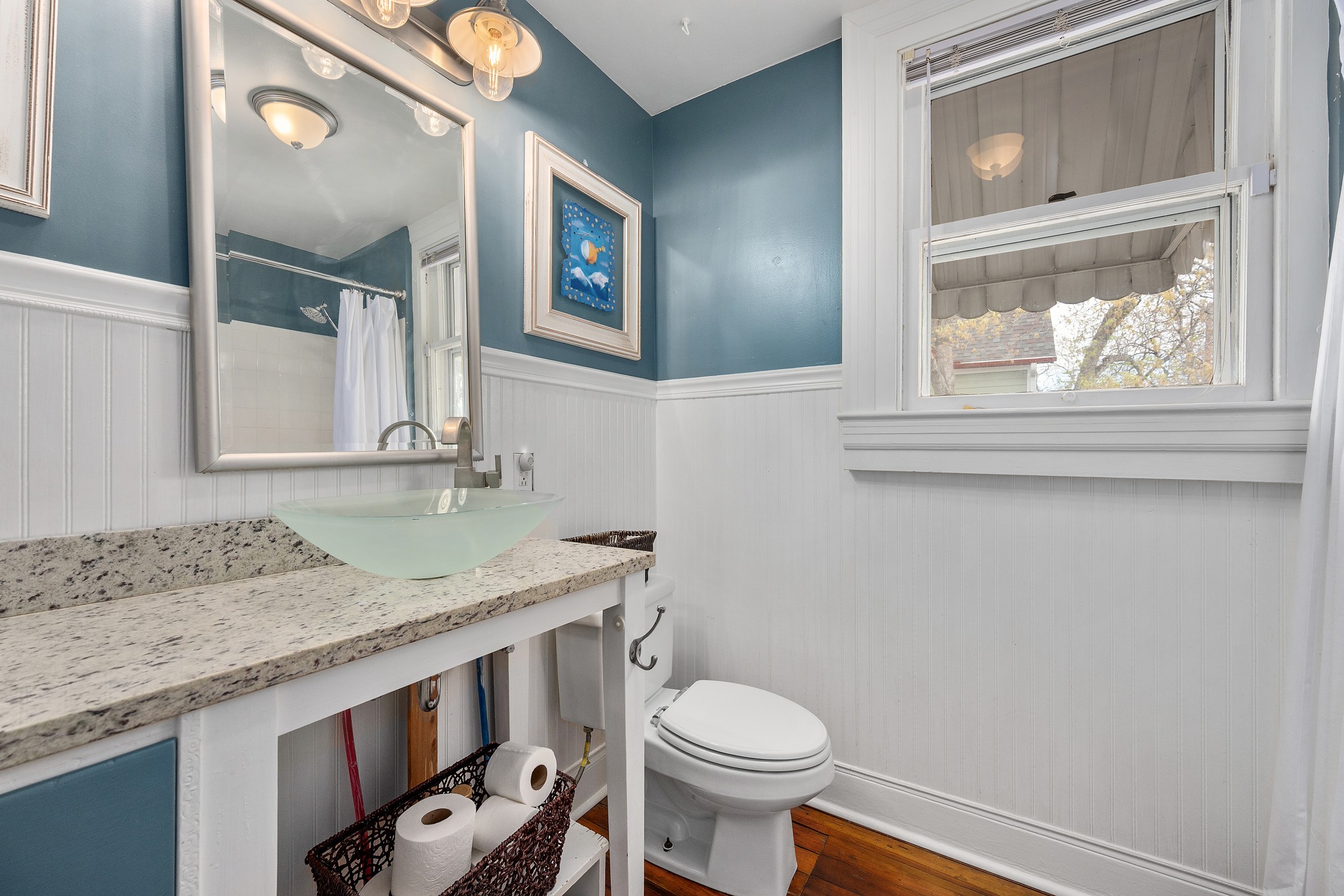603 East 7th Street Georgetown, TX 78626 - Photo 18 of 33 a bathroom with a granite countertop toilet sink and mirror