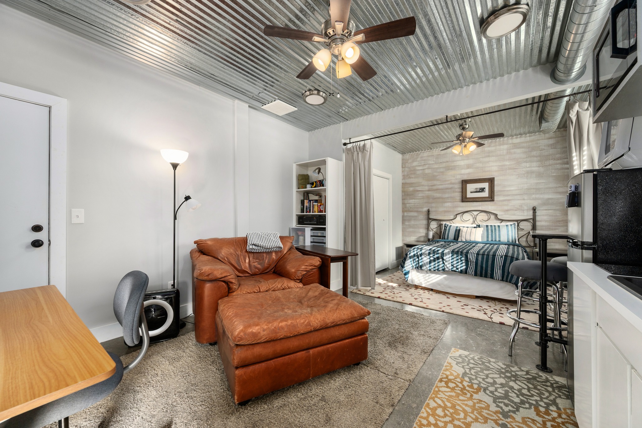 603 East 7th Street Georgetown, TX 78626 - Photo 28 of 33 a living room with furniture a chandelier and a rug