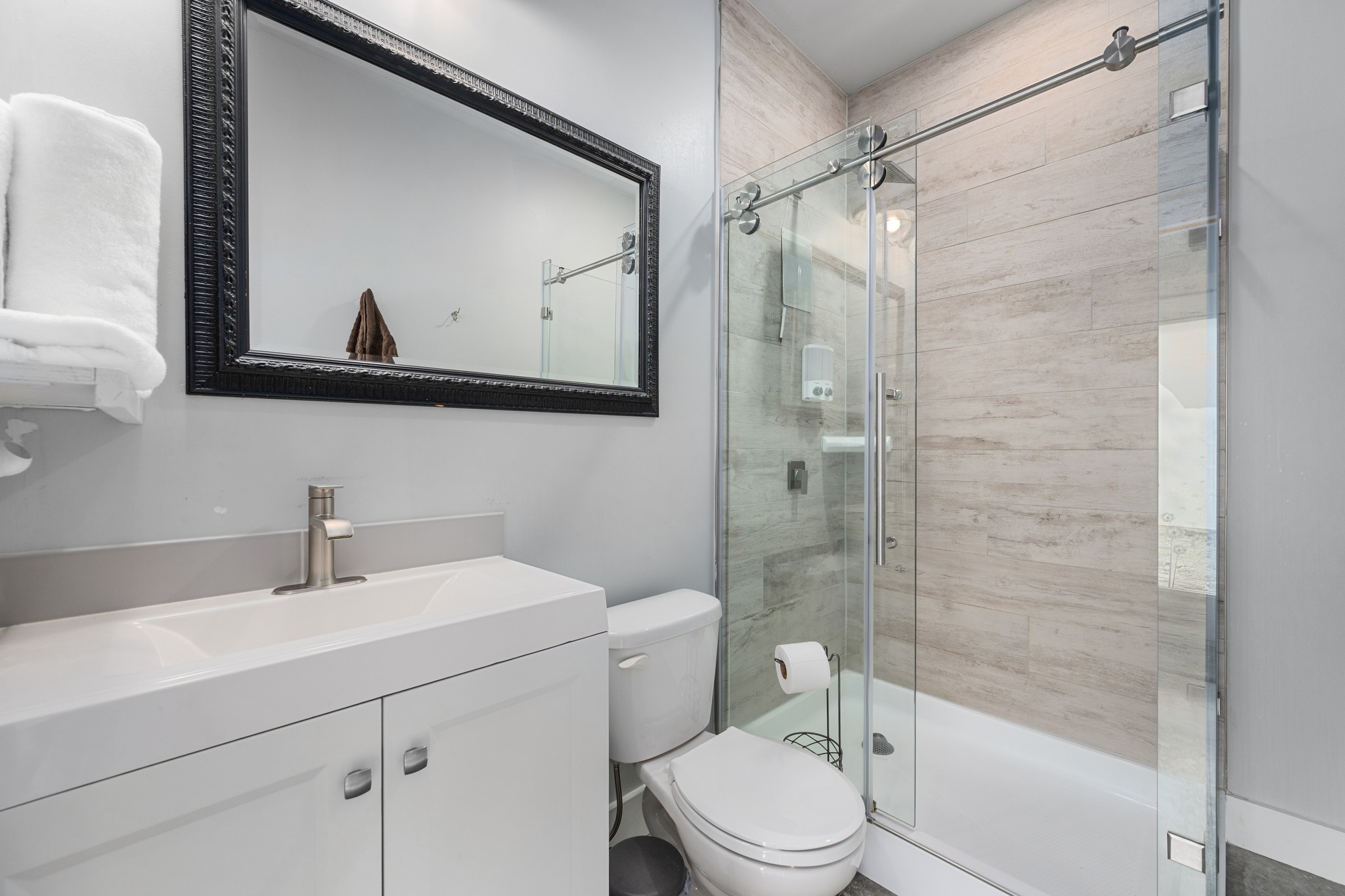 603 East 7th Street Georgetown, TX 78626 - Photo 30 of 33 a bathroom with a sink a mirror a toilet and shower