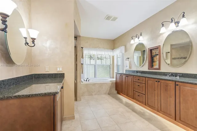a view of a kitchen with kitchen island granite countertop furniture and a refrigerator