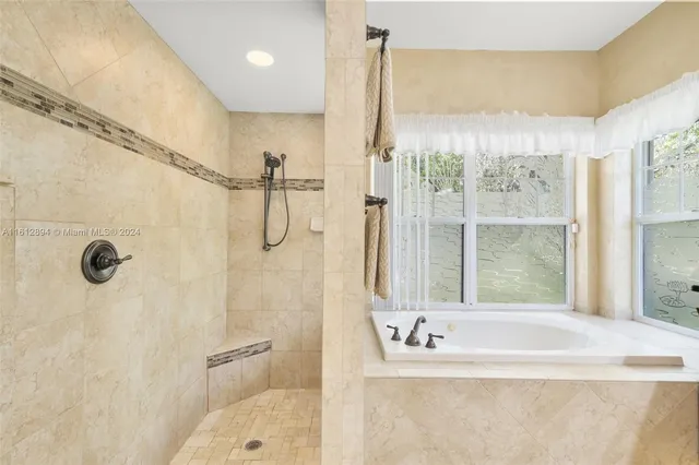 a kitchen with stainless steel appliances a table chairs and refrigerator