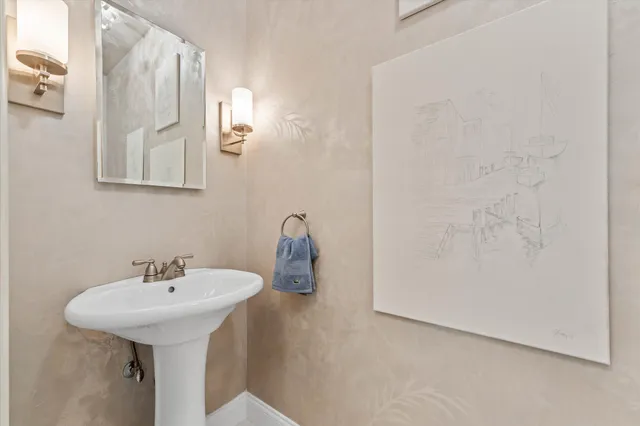 a patio with a table and chairs and potted plants