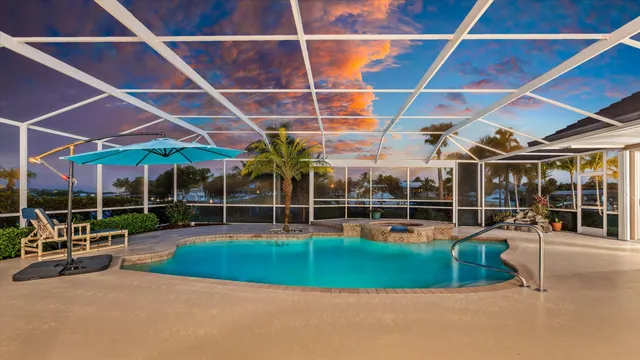 a view of a livingroom with furniture and floor to ceiling window