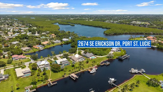 an aerial view of residential houses with outdoor space and street view