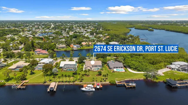 an aerial view of residential houses with outdoor space and swimming pool