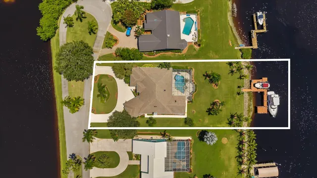an aerial view of water body with boats and trees in the background
