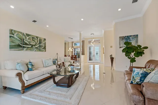 a living room with furniture flowers and a chandelier