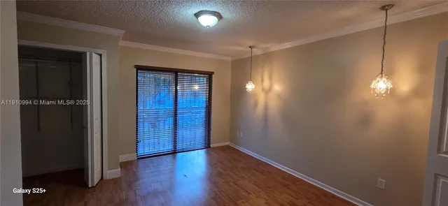 an empty room with wooden floor and closet