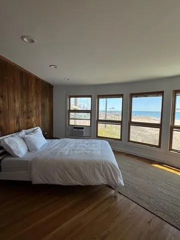 a bedroom with a large bed and a window