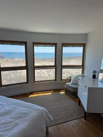 a living room with large window and a wooden floor