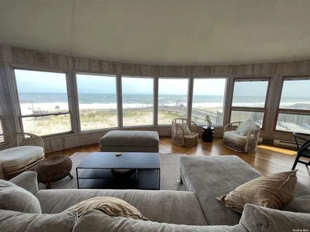 a living room with furniture and large windows