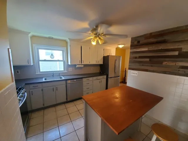 a kitchen with stainless steel appliances a sink and a refrigerator