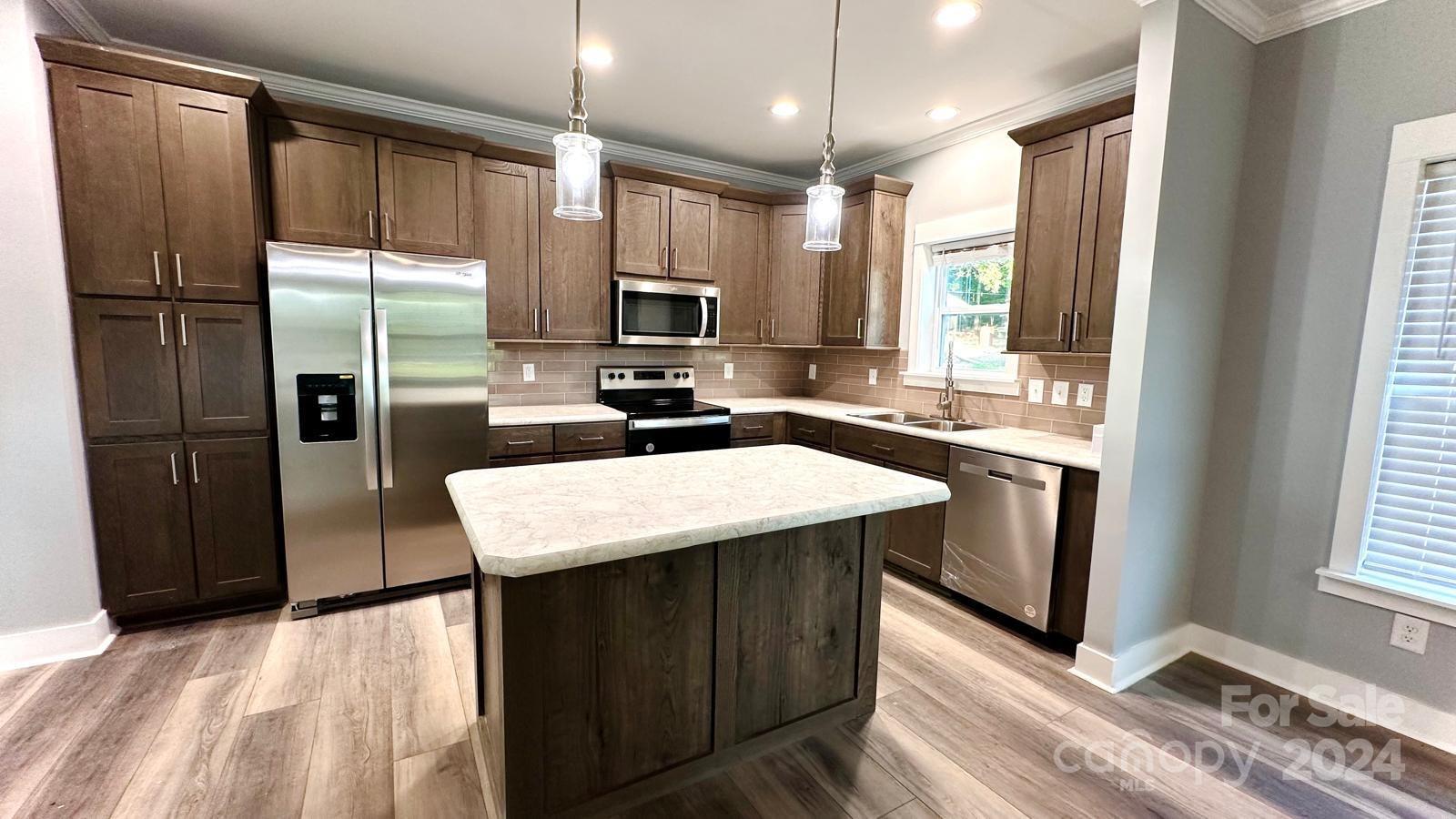 4847 Charlie Crawley Road, Unit 2 Morganton, NC 28655 - Photo 11 of 36 a kitchen with kitchen island a sink appliances and cabinets