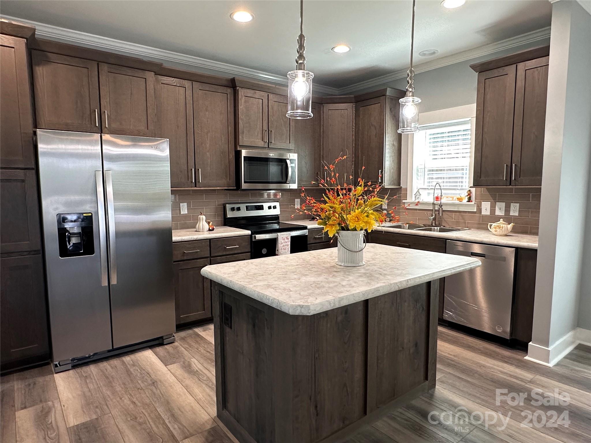 4847 Charlie Crawley Road, Unit 2 Morganton, NC 28655 - Photo 13 of 36 a kitchen with stainless steel appliances granite countertop a sink a stove a refrigerator a center island and cabinets