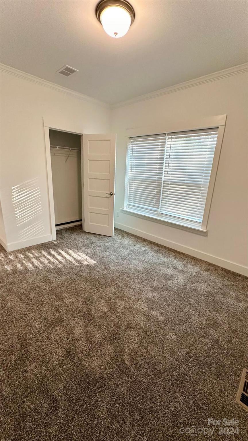 4847 Charlie Crawley Road, Unit 2 Morganton, NC 28655 - Photo 19 of 36 an empty room with windows