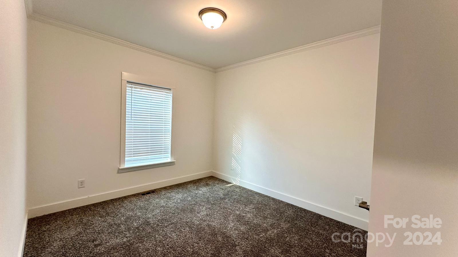 4847 Charlie Crawley Road, Unit 2 Morganton, NC 28655 - Photo 20 of 36 an empty room with a window