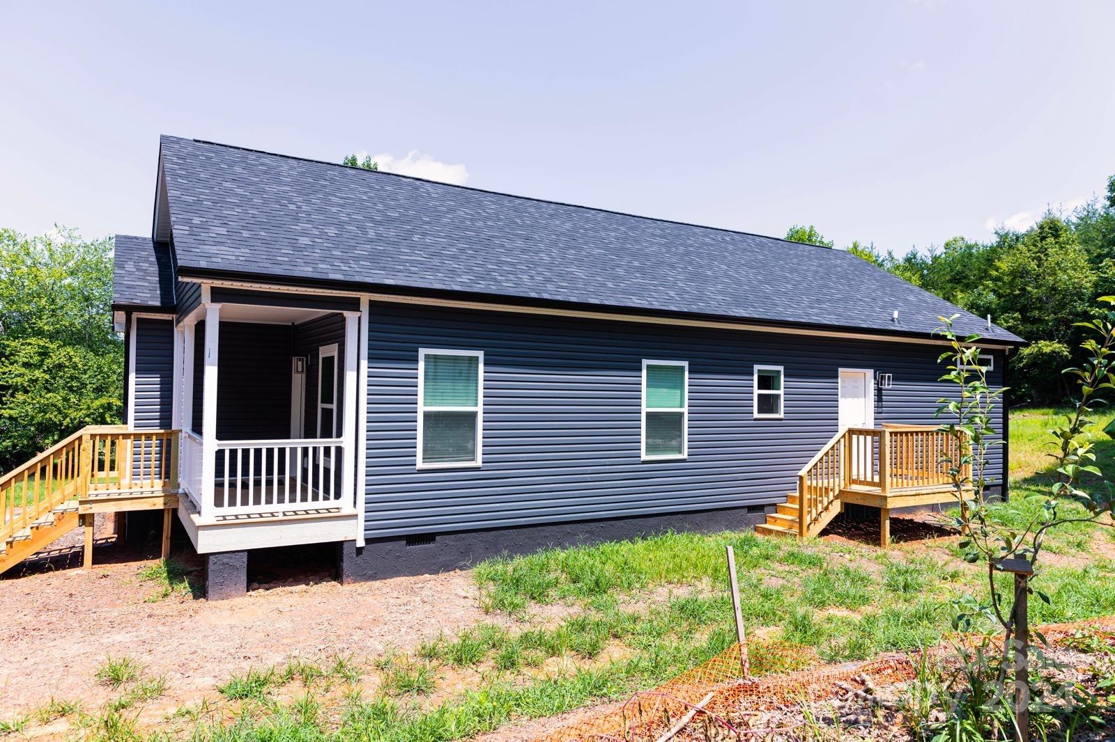 4847 Charlie Crawley Road, Unit 2 Morganton, NC 28655 - Photo 2 of 36 a front view of a house with a garden