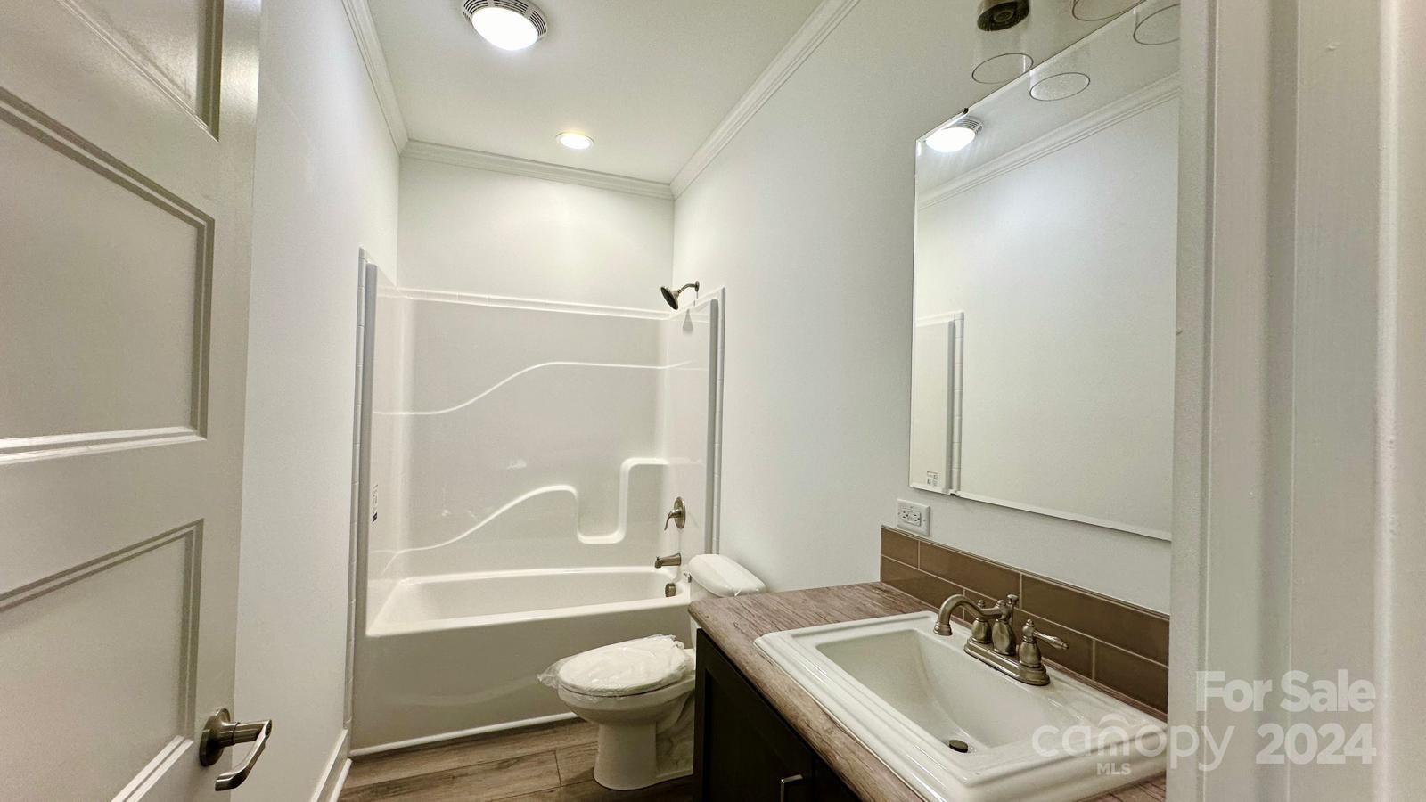 4847 Charlie Crawley Road, Unit 2 Morganton, NC 28655 - Photo 21 of 36 a bathroom with a sink mirror toilet and bathtub