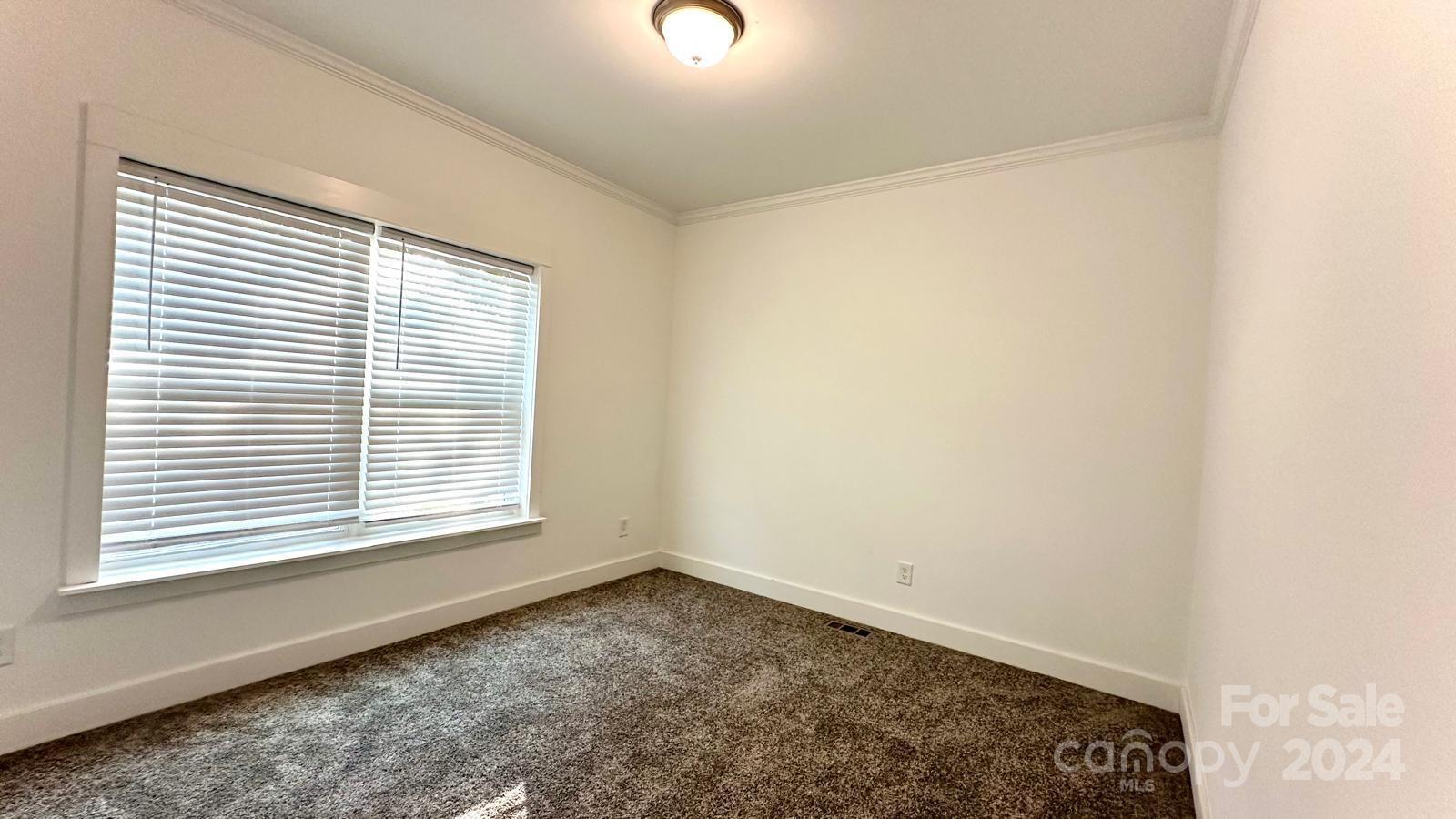 4847 Charlie Crawley Road, Unit 2 Morganton, NC 28655 - Photo 23 of 36 an empty room with a window