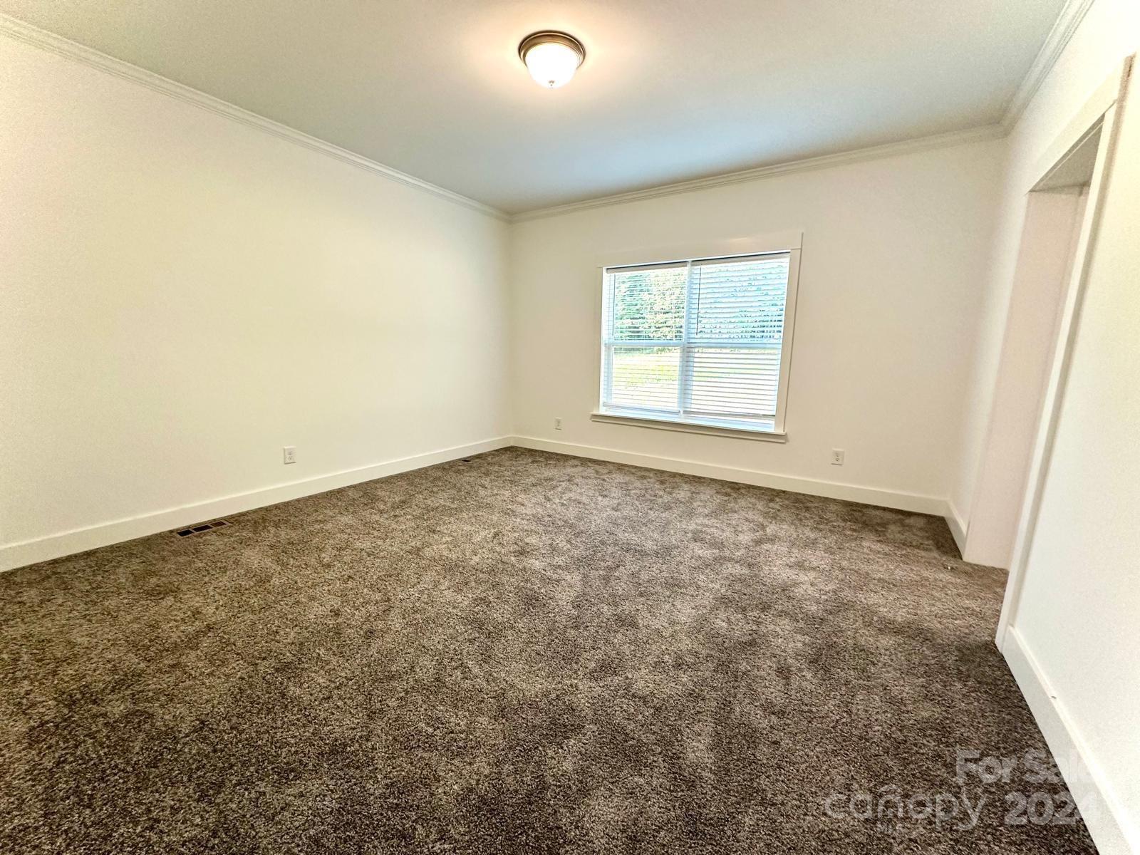 4847 Charlie Crawley Road, Unit 2 Morganton, NC 28655 - Photo 26 of 36 an empty room with a window