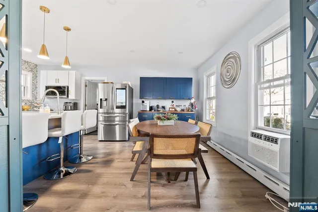 a kitchen with stainless steel appliances kitchen island granite countertop a sink dishwasher stove and wooden cabinets