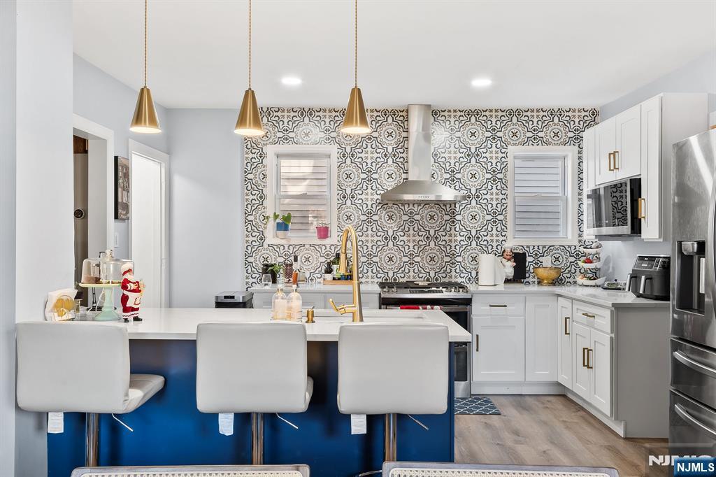 71 Spring Street Nutley, NJ 07110 - Photo 18 of 50 a very nice looking kitchen with granite countertop a stove a sink dishwasher and a wooden cabinets
