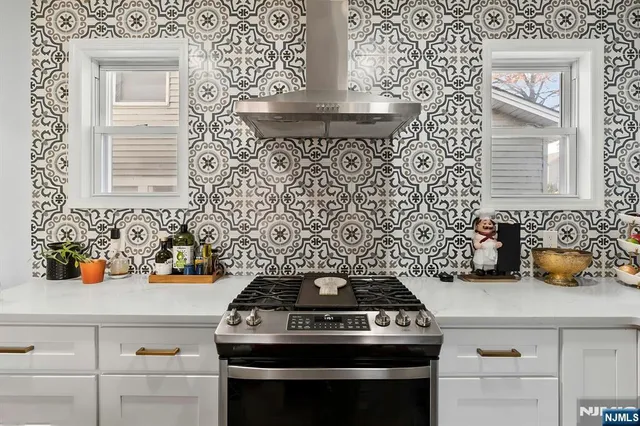 a bathroom with a sink a toilet a mirror and shower