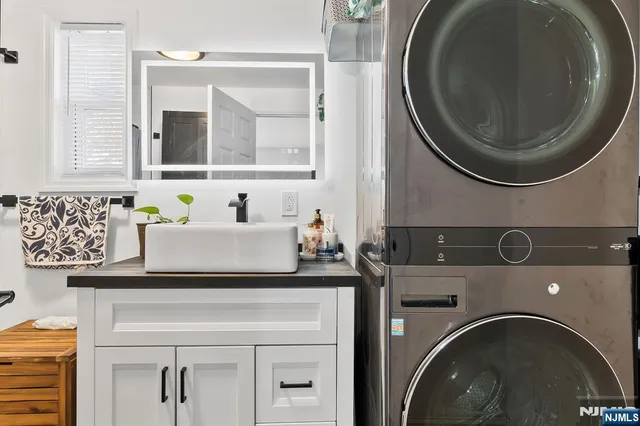 a utility room with sink dryer and washer