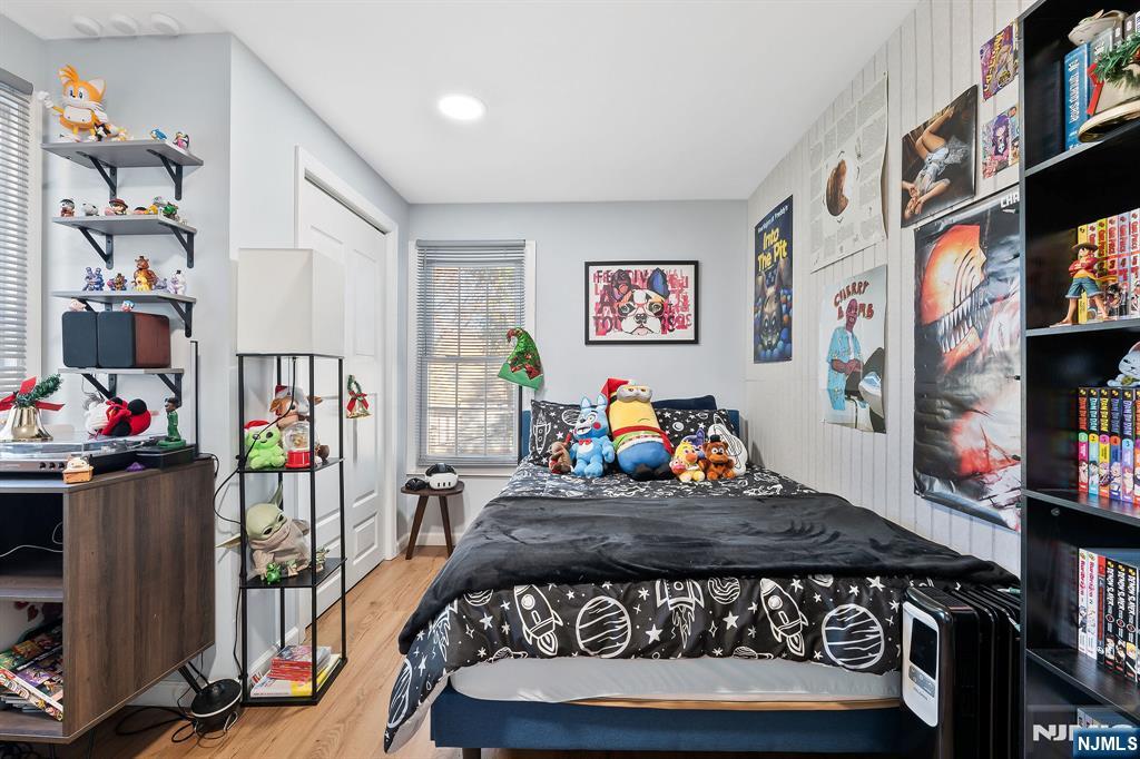 71 Spring Street Nutley, NJ 07110 - Photo 32 of 50 a bed room with a bed and a book shelf