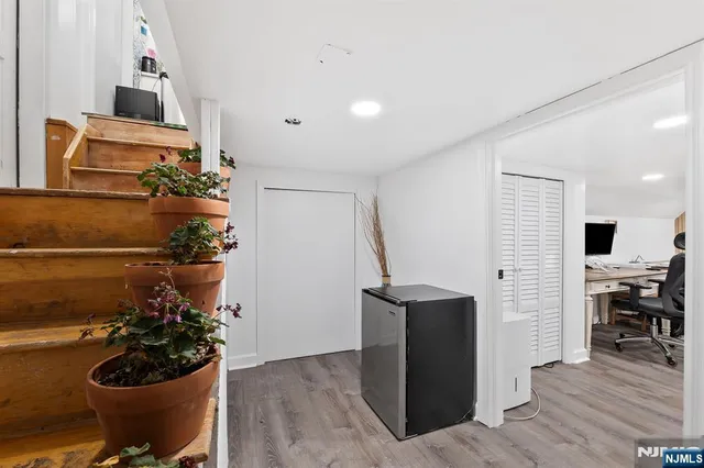 a view of a livingroom with workspace and a window