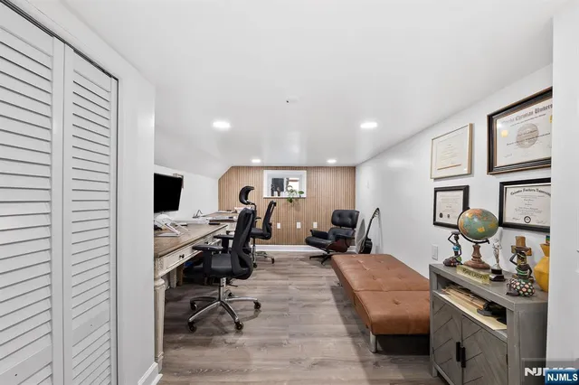 a view of a workspace with furniture and a flat screen tv