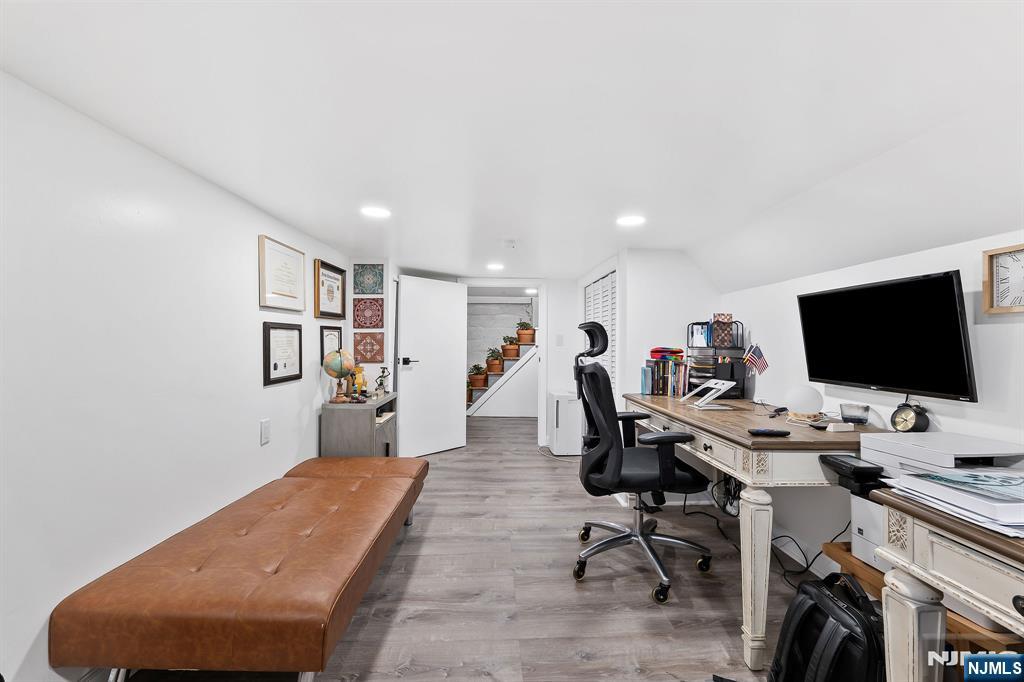 71 Spring Street Nutley, NJ 07110 - Photo 36 of 50 a view of a workspace with furniture and a flat screen tv
