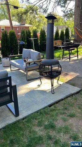 a view of a patio with couches and a potted plant on a table and chairs