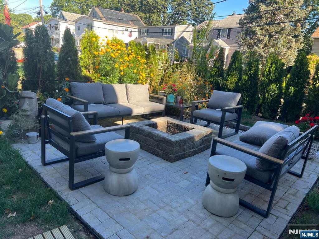 71 Spring Street Nutley, NJ 07110 - Photo 48 of 50 a view of a patio with couches and a potted plant on a table and chairs