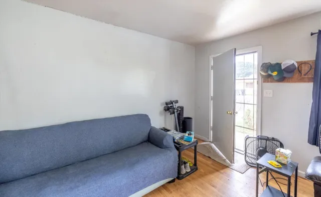 a living room with furniture a large window and a flat screen tv