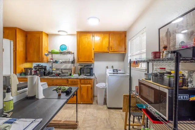 a kitchen with a stove a sink dishwasher and a refrigerator