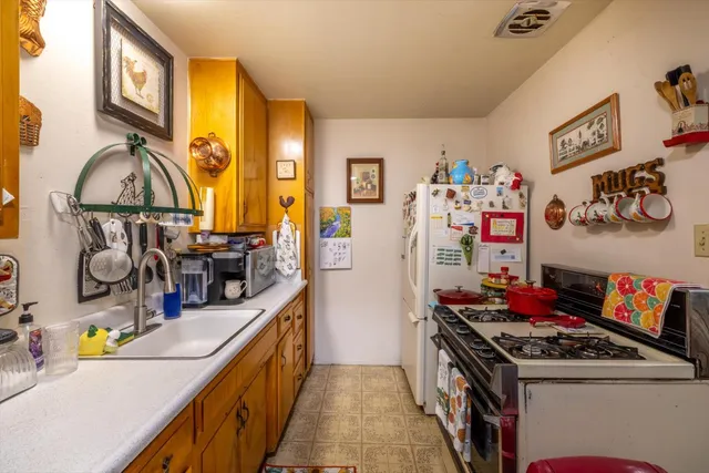 a kitchen with stainless steel appliances granite countertop a stove and a sink