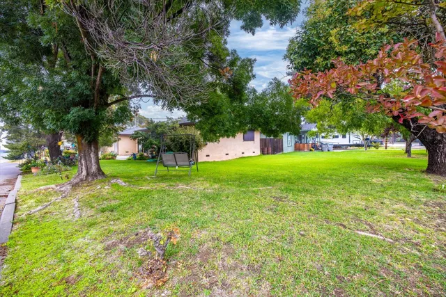 a view of a backyard with sitting area