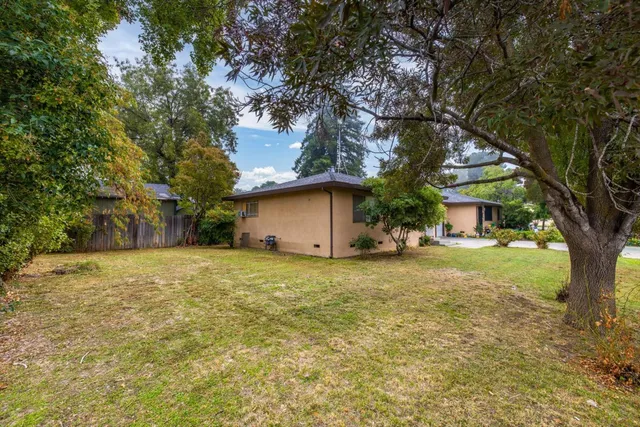 a front view of house with yard and trees
