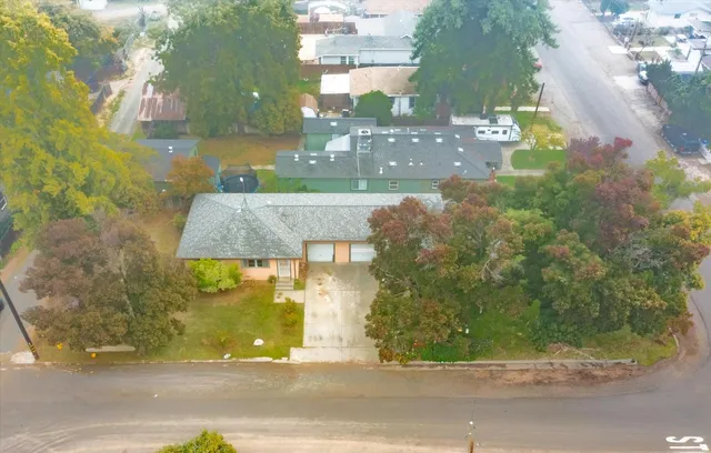 an aerial view of a house with a yard