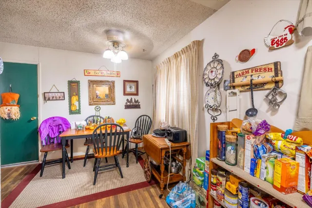 a living room with furniture a baby crib and a table