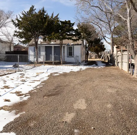 a view of a house with snow on the road