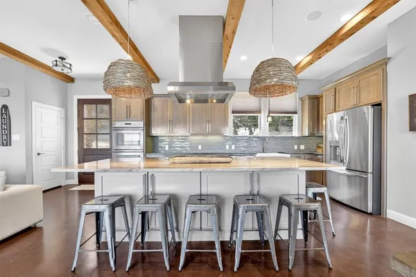 a large kitchen with a table and chairs